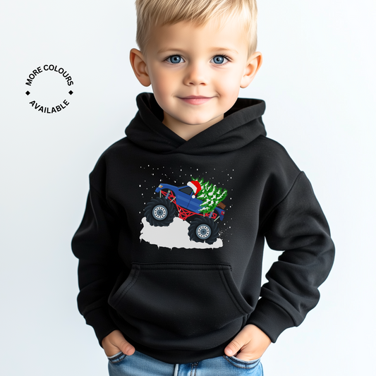 A child wearing a black hoodie with a Christmas-themed monster truck graphic in front.