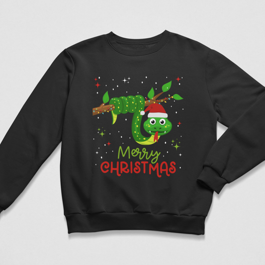A kids black crewneck sweatshirt featuring a festive graphic of a green cartoon snake wearing a red Santa hat on a branch, with 'Merry Christmas' written below in green and red text, shown against a light grey background.