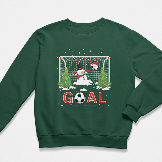 Children's dark green crewneck sweatshirt featuring a festive Christmas soccer graphic on the front. The graphic features a snowman goalkeeper and a soccer ball in front of a goal net with snow-covered trees and the word 'GOAL' in red letters.