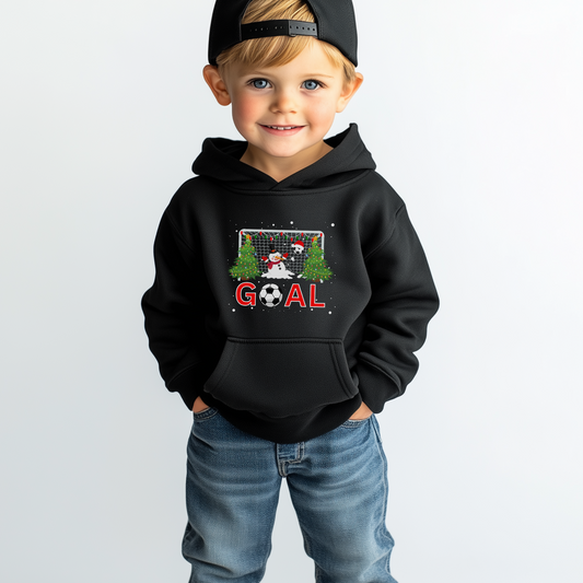 A child wearing a black hoodie with a graphic of a snowman, a football with a Santa hat, and a goal post with Christmas lights.