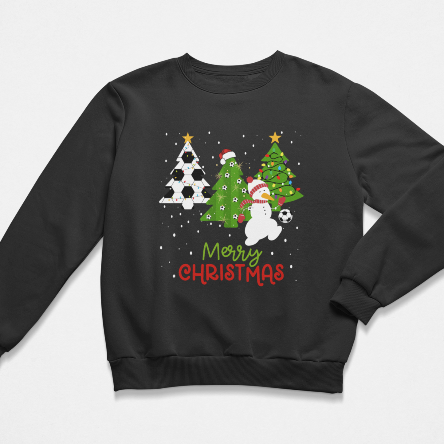 Kids black Christmas sweatshirt with football-themed xmas trees, a snowman in a Santa hat playing with a football, falling snow, and “Merry Christmas” text in red and green.