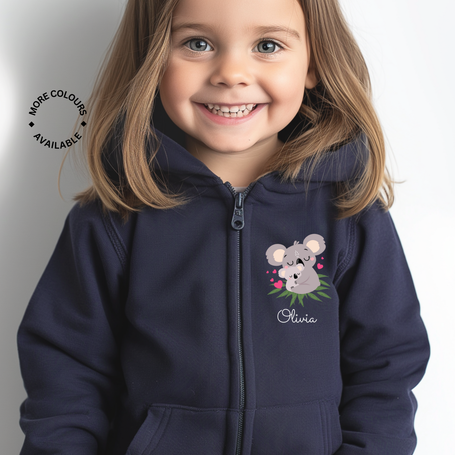 Little girl smiling and wearing a navy full zip hoodie with a small Koala motif and name Olivia underneath