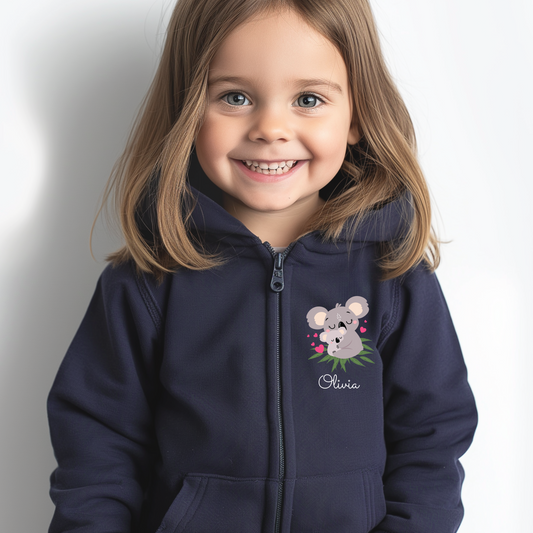 Little girl smiling and wearing a navy full zip hoodie with a small Koala motif and name Olivia underneath