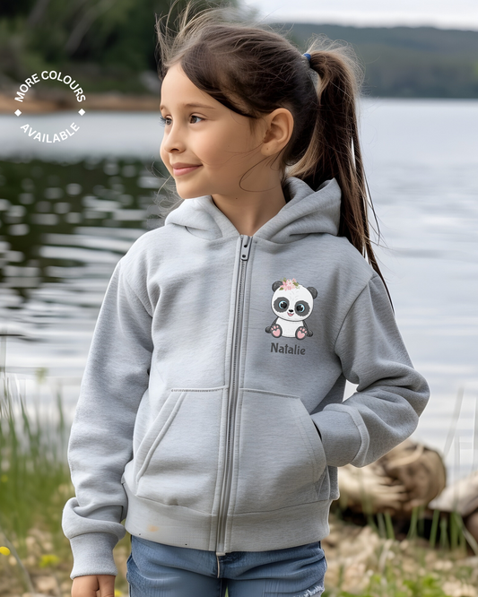 Girl standing next to a lake wearing a heather grey zipped hoodie with a panda motif with the name Natalie printed underneath.