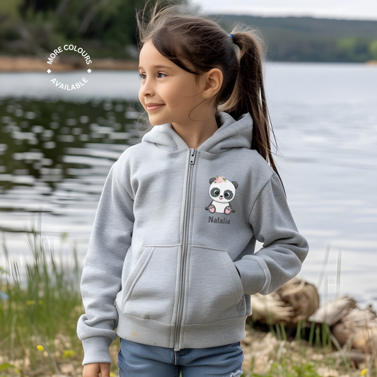 Girl standing next to a lake wearing a heather grey zipped hoodie with a printe panda motif with the name Natalie printed underneath.