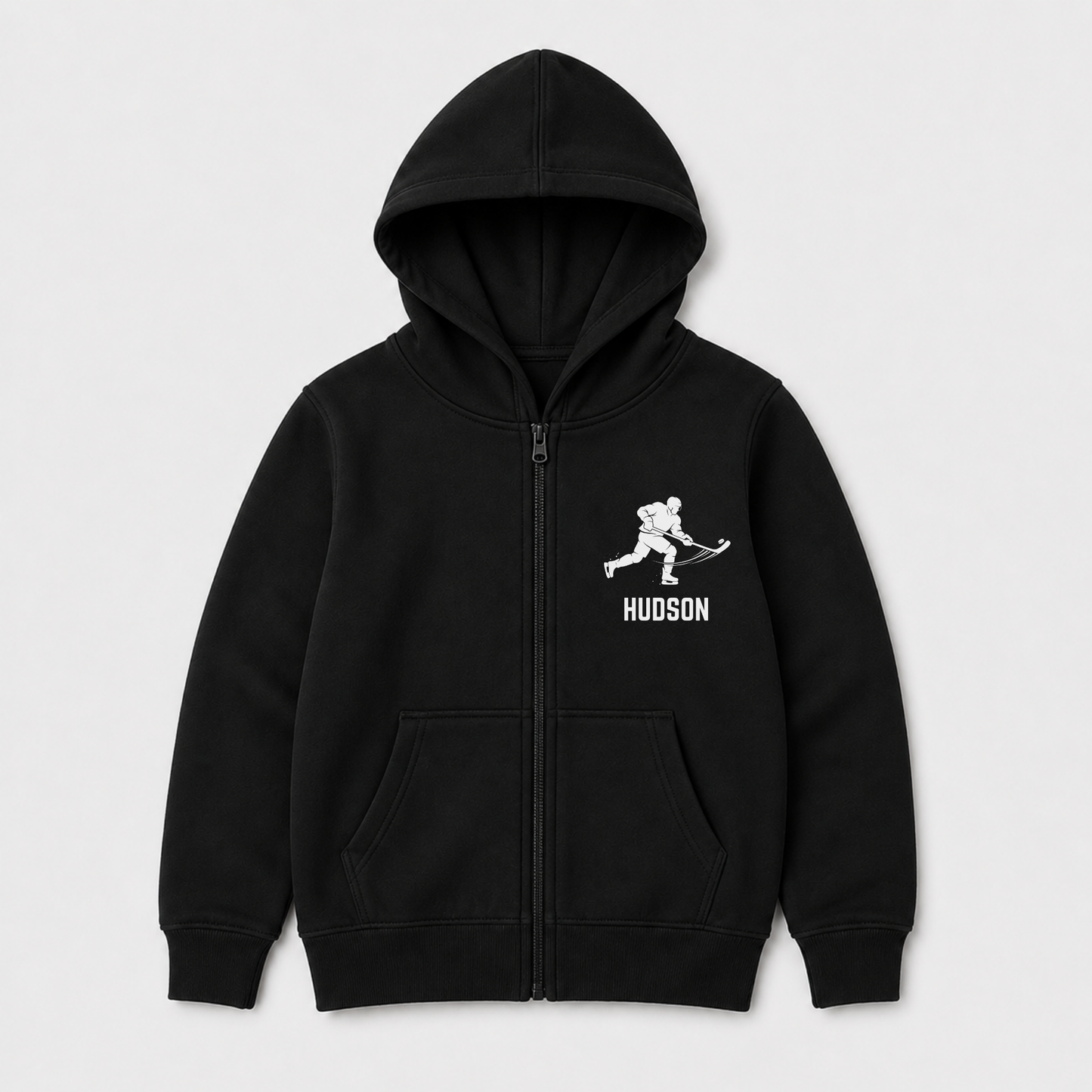 Kids black zip-up hoodie with a white hockey player graphic with custom name underneath. 