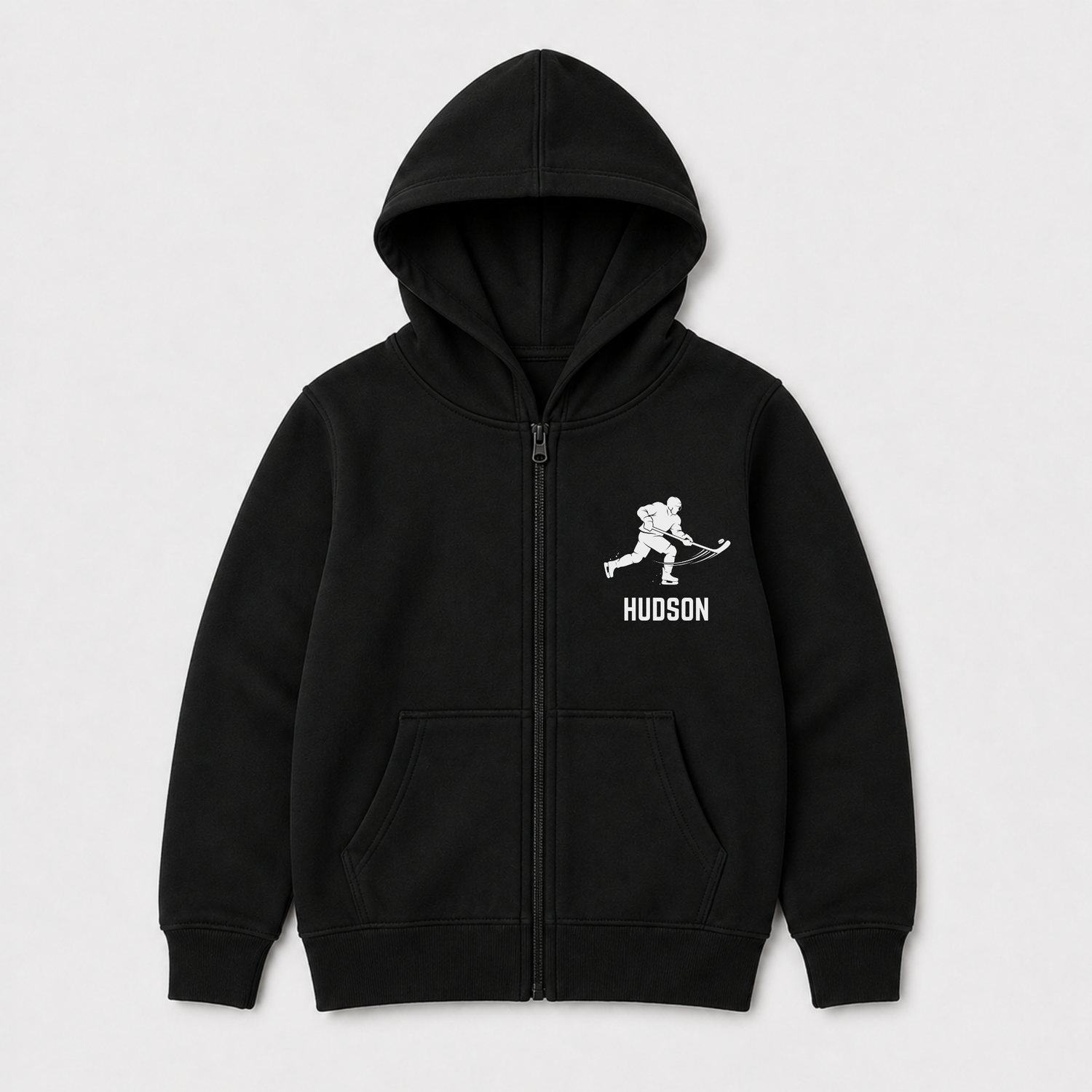 Kids black zip-up hoodie with a white hockey player graphic with custom name underneath. 