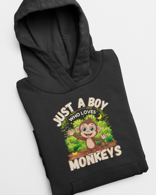 Kids “Just A Boy Who Loves Monkeys” black hoodie featuring a colourful monkey in the jungle graphic - hoodie flat and folded