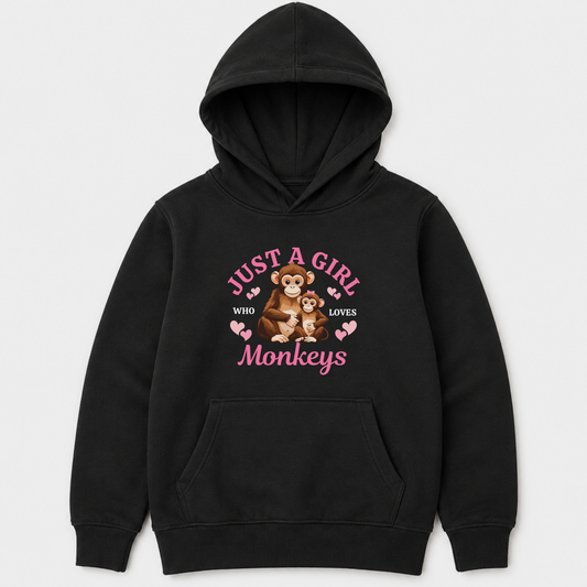 A kids black pullover hoodie with a front graphic that reads 'JUST A GIRL WHO LOVES Monkeys' in pink, featuring an illustration of a monkey holding a teddy bear, on a light grey background.