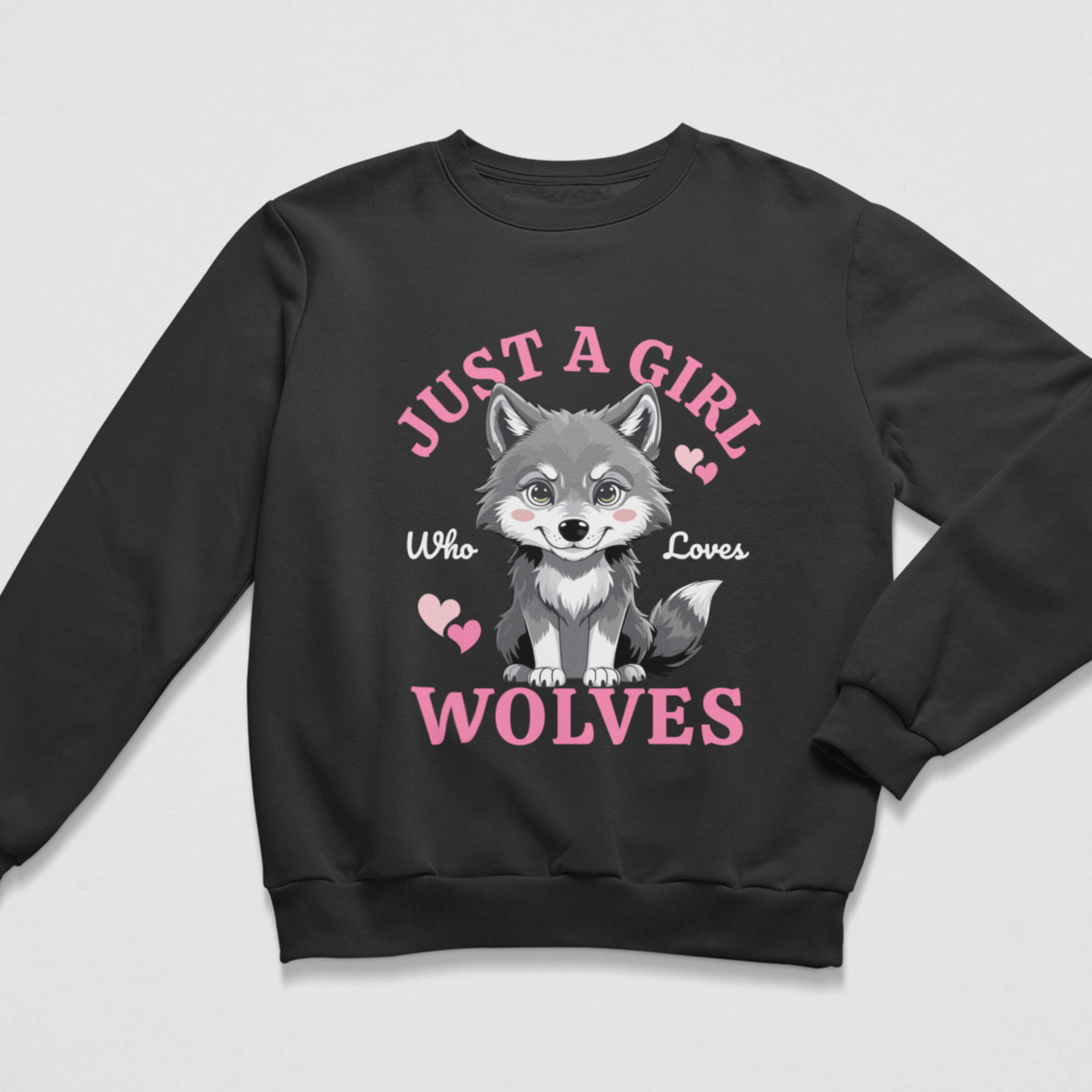 A kids black crewneck sweatshirt featuring a graphic print of a cute cartoon wolf with the text 'JUST A GIRL Who Loves WOLVES' in pink and white, displayed on a light grey background.