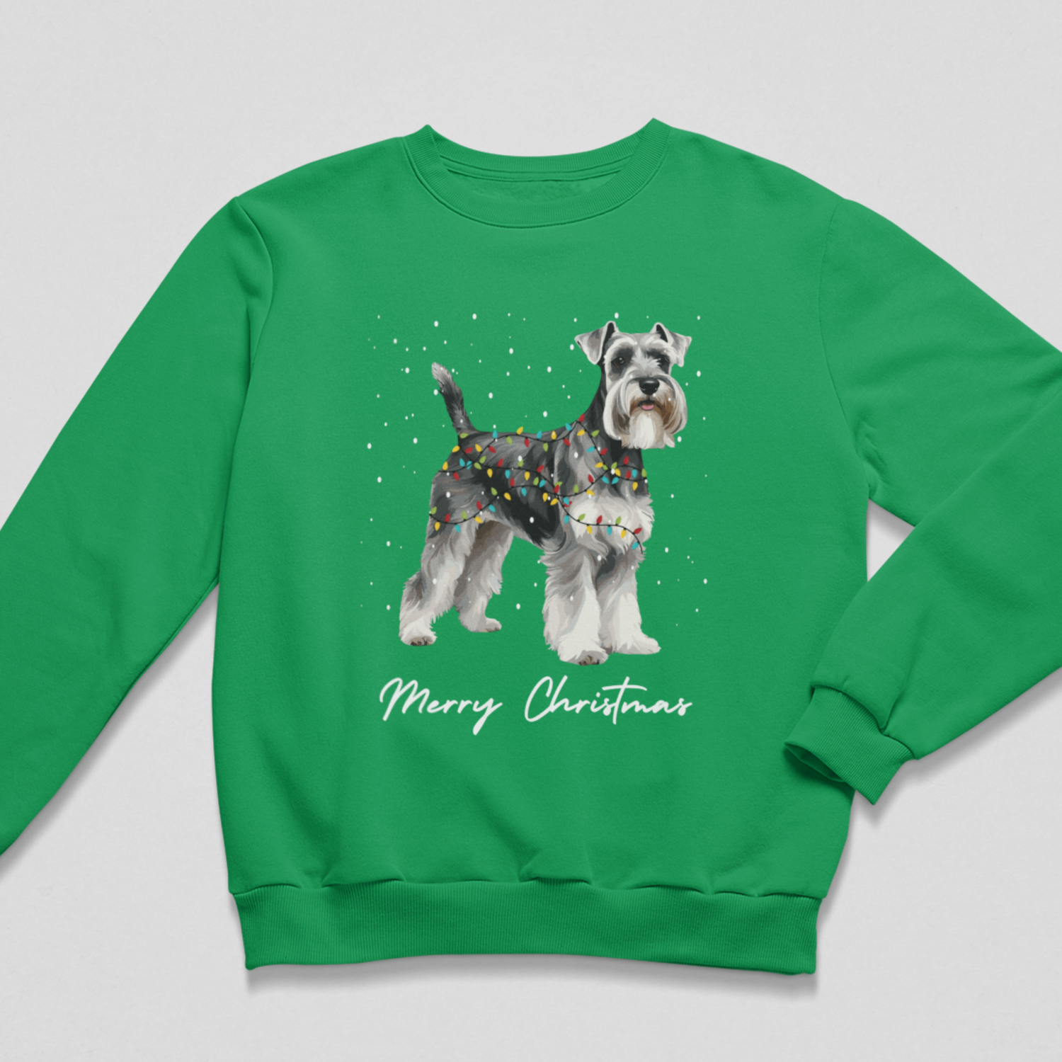 Flat lay view of a bright Kelly Green kids Christmas sweatshirt displaying a festive Schnauzer graphic and white Merry Christmas script.