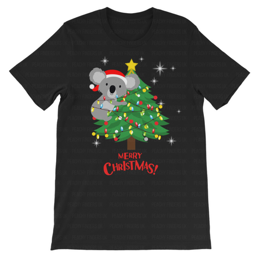 A children's black cotton t-shirt with a graphic of a koala bear wearing a Santa hat climbing a Christmas tree with the text 'Merry Christmas!' displayed.