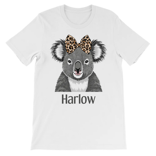 Kids white cotton tee featuring a cute grey koala illustration with a leopard print bow on its head with a custom name printed underneath in grey text.