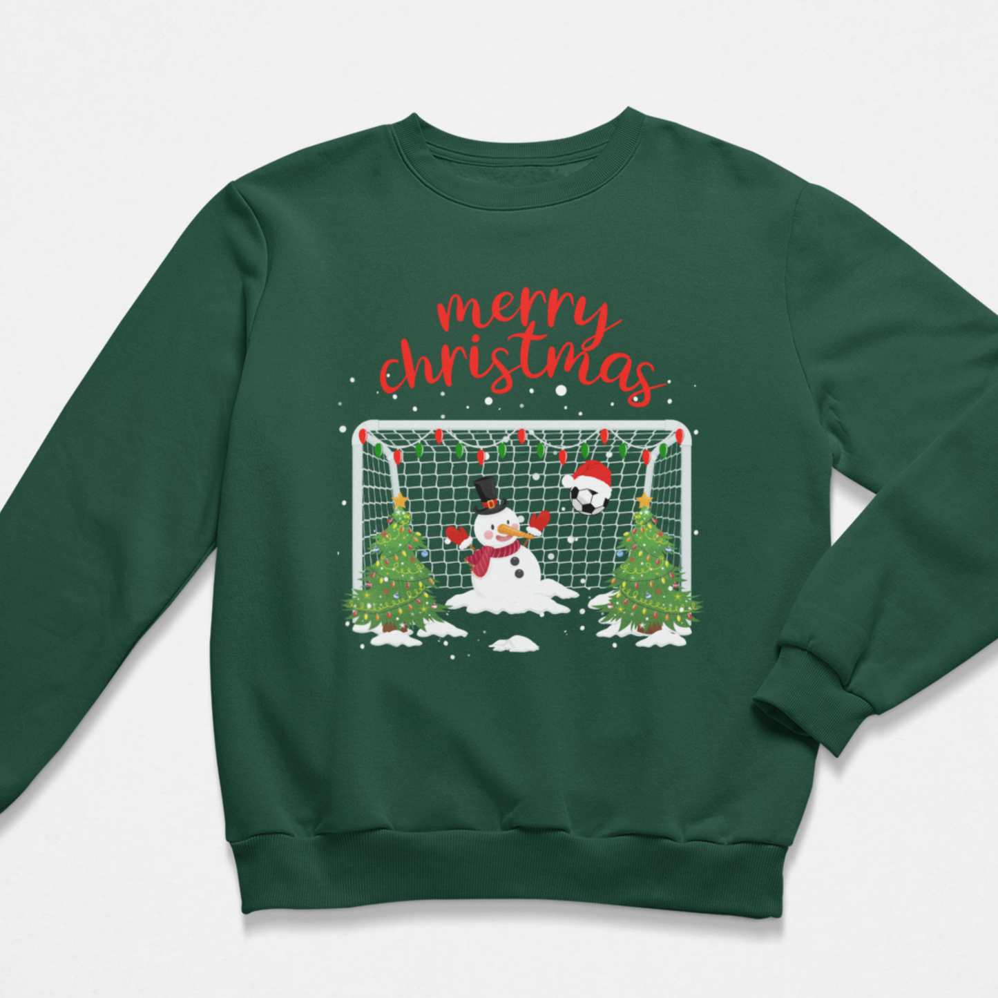 A boys dark green crewneck sweatshirt featuring a festive Christmas graphic with the words 'merry christmas' in red script above a snowman, a soccer ball, and two Christmas trees in front of a goal net.