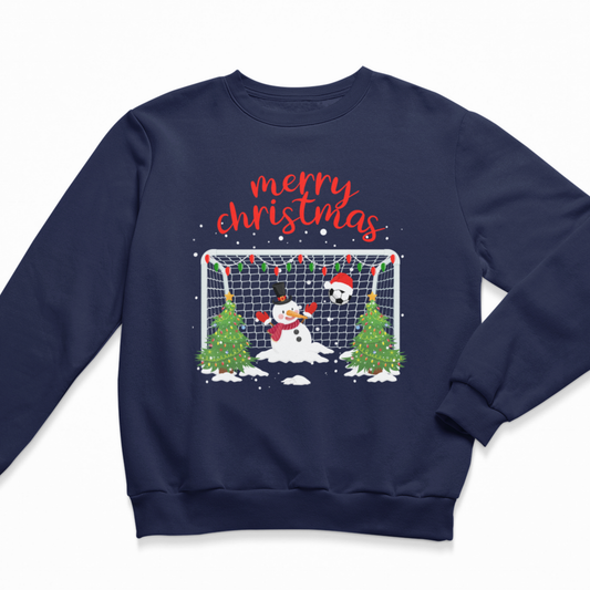 A kids navy blue crewneck sweatshirt featuring a festive Christmas graphic with a snowman goalie, a soccer ball, Christmas trees, and the text 'merry christmas' in red script.