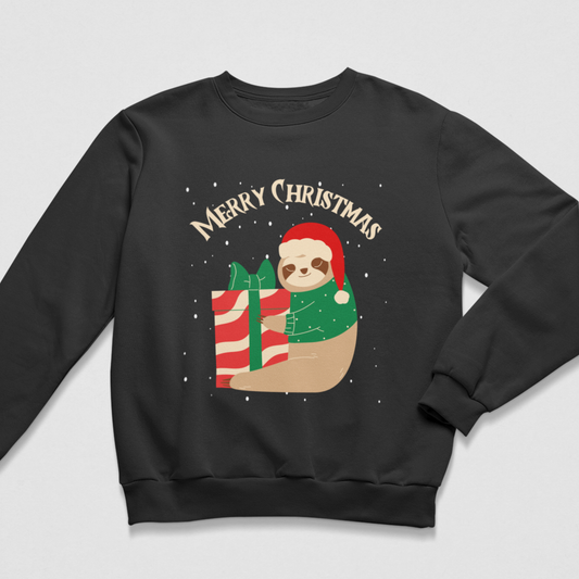 A kids black crewneck sweatshirt featuring a festive graphic of a sloth wearing a red Santa hat and green sweater, next to a red and white striped gift box, with 'MERRY CHRISTMAS' written above in beige arched text.