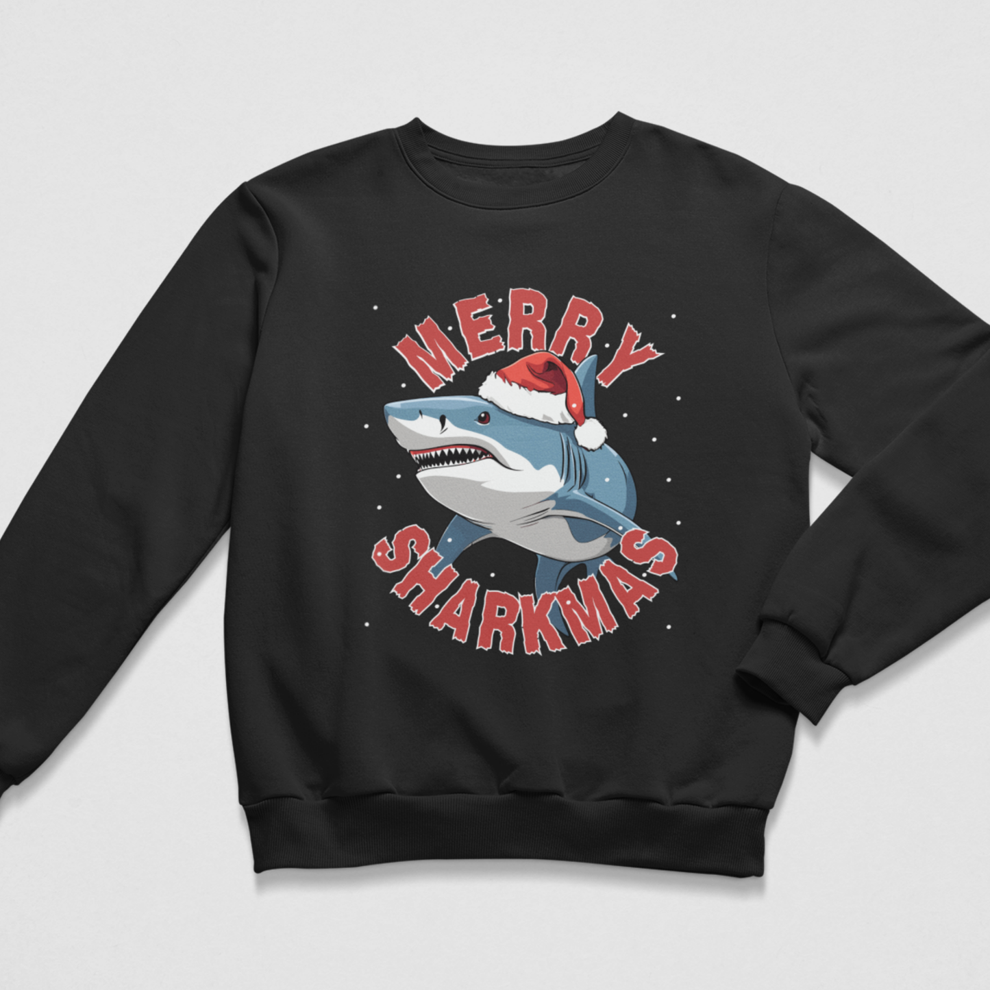 A kids black crewneck sweatshirt featuring a festive graphic of a shark wearing a Santa hat, surrounded by the text 'MERRY SHARKMAS' in red letters, set against a light grey background.