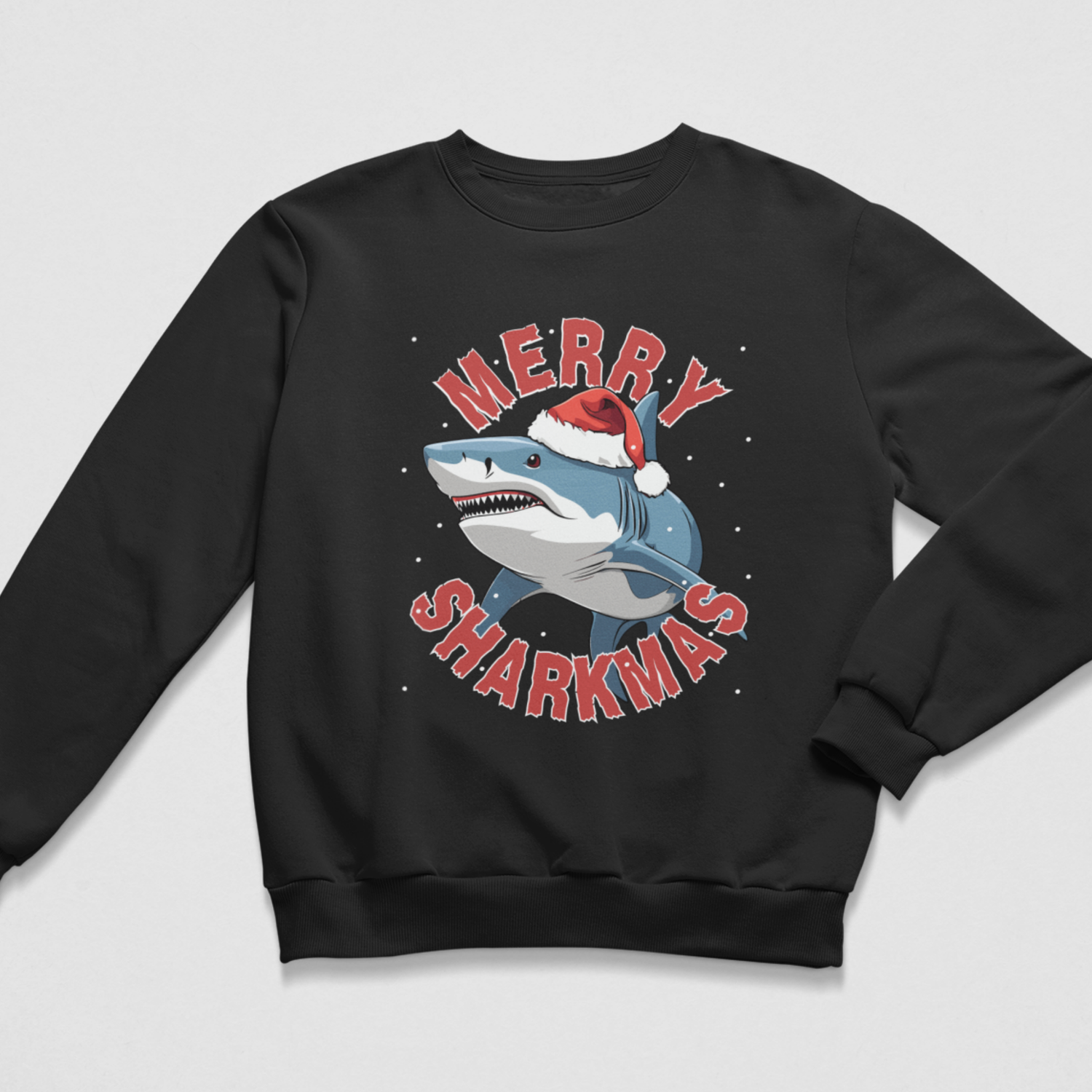 A kids black crewneck sweatshirt featuring a festive graphic of a shark wearing a Santa hat, surrounded by the text 'MERRY SHARKMAS' in red letters, set against a light grey background.