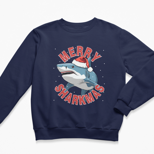 A kids navy blue crewneck sweatshirt featuring a festive graphic of a blue shark wearing a red Santa hat, surrounded by the text 'MERRY SHARKMAS' in red with white outlines, set against a clean white background.