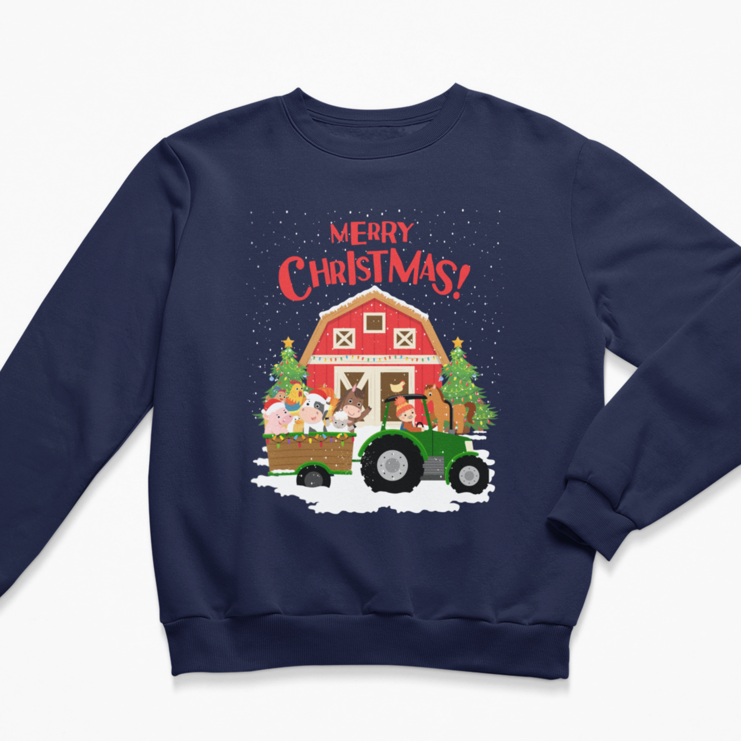 Flat lay of a navy blue kids Christmas sweatshirt featuring a green tractor pulling farm animals past a snowy red barn with 'Merry Christmas!' text