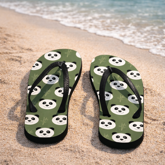 Flip-flops with panda design on a sandy beach