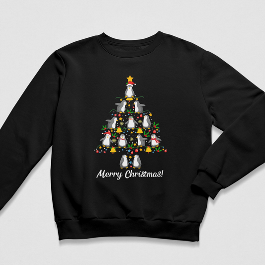 Flat lay of a black kids Christmas crewneck sweatshirt featuring cute penguins stacked in the shape of a Christmas tree with festive decorations, stars, and 'Merry Christmas!' printed in white script below.