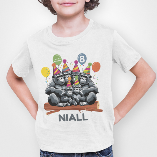 Boy wears personalised birthday t-shirt with cartoon gorilla family and custom name and age.