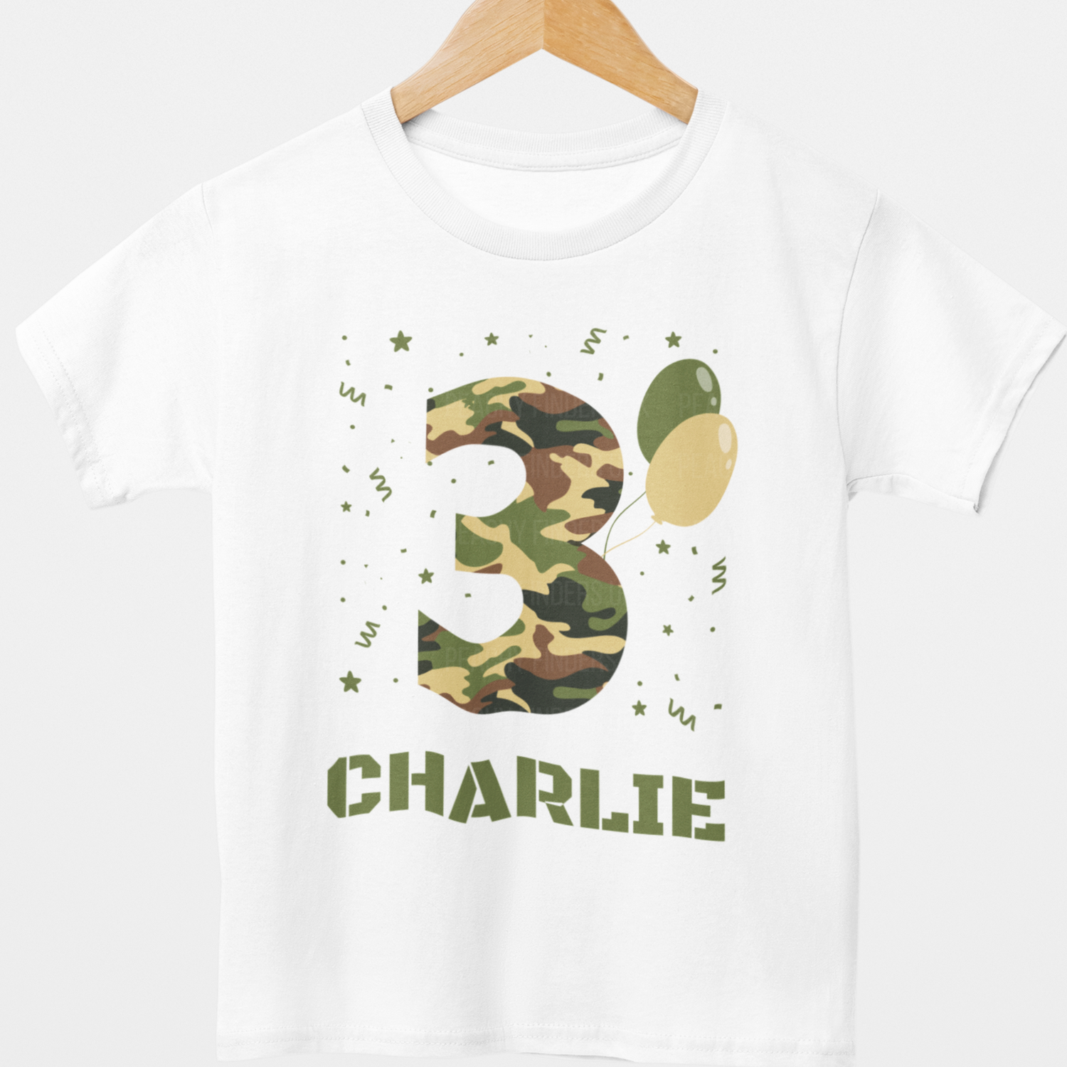 Personalised kids camouflage 3rd birthday t-shirt with name Charlie - styled on a hanger.