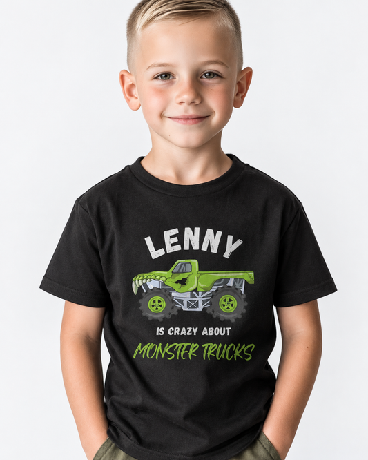 A young boy wearing a black custom graphic t-shirt with a green monster truck and the text 'LENNY IS CRAZY ABOUT MONSTER TRUCKS'.