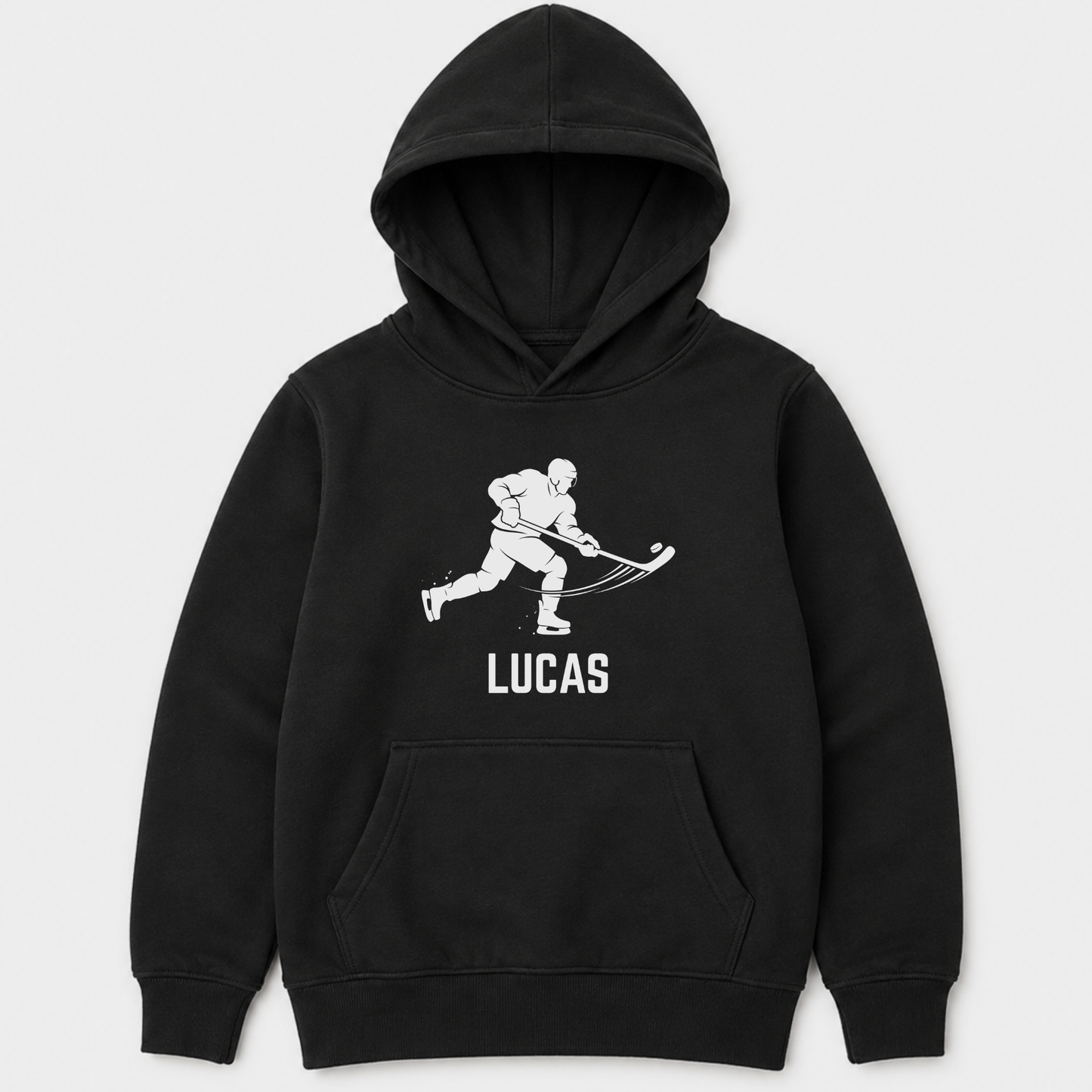 Kids black pullover hoodie with a white graphic of a hockey player and the name 'LUCAS' printed on the chest, displayed against a light grey background.