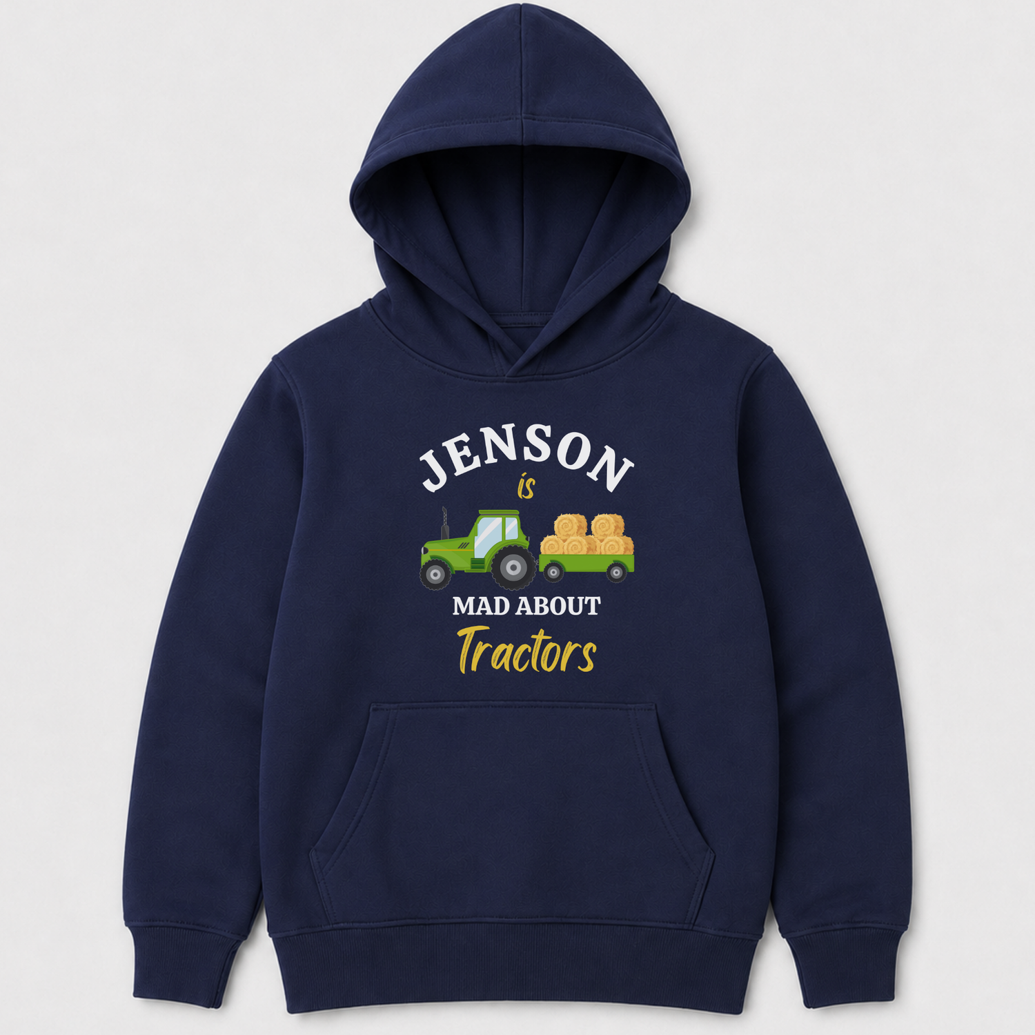 A navy blue kids pullover hoodie with a front graphic that reads 'JENSON is MAD ABOUT Tractors' around an illustration of a green tractor pulling a yellow hay cart, shown on a light grey background.