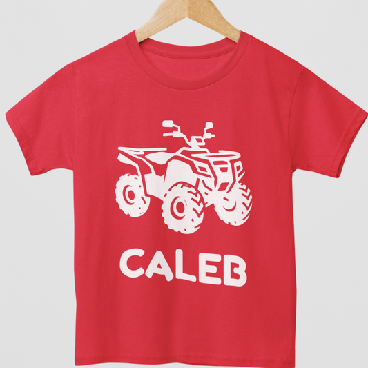 Red kids quad bike t-shirt on hanger with white ATV graphic and personalised name “Caleb”.
