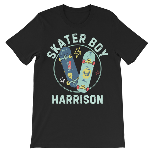 A kids black short-sleeve crewneck t-shirt featuring a graphic print on the front. The design displays two skateboards (one dark blue, one light blue) inside a circular outline, with the text 'SKATER BOY' arched above and 'HARRISON' printed below in a distressed light blue font.