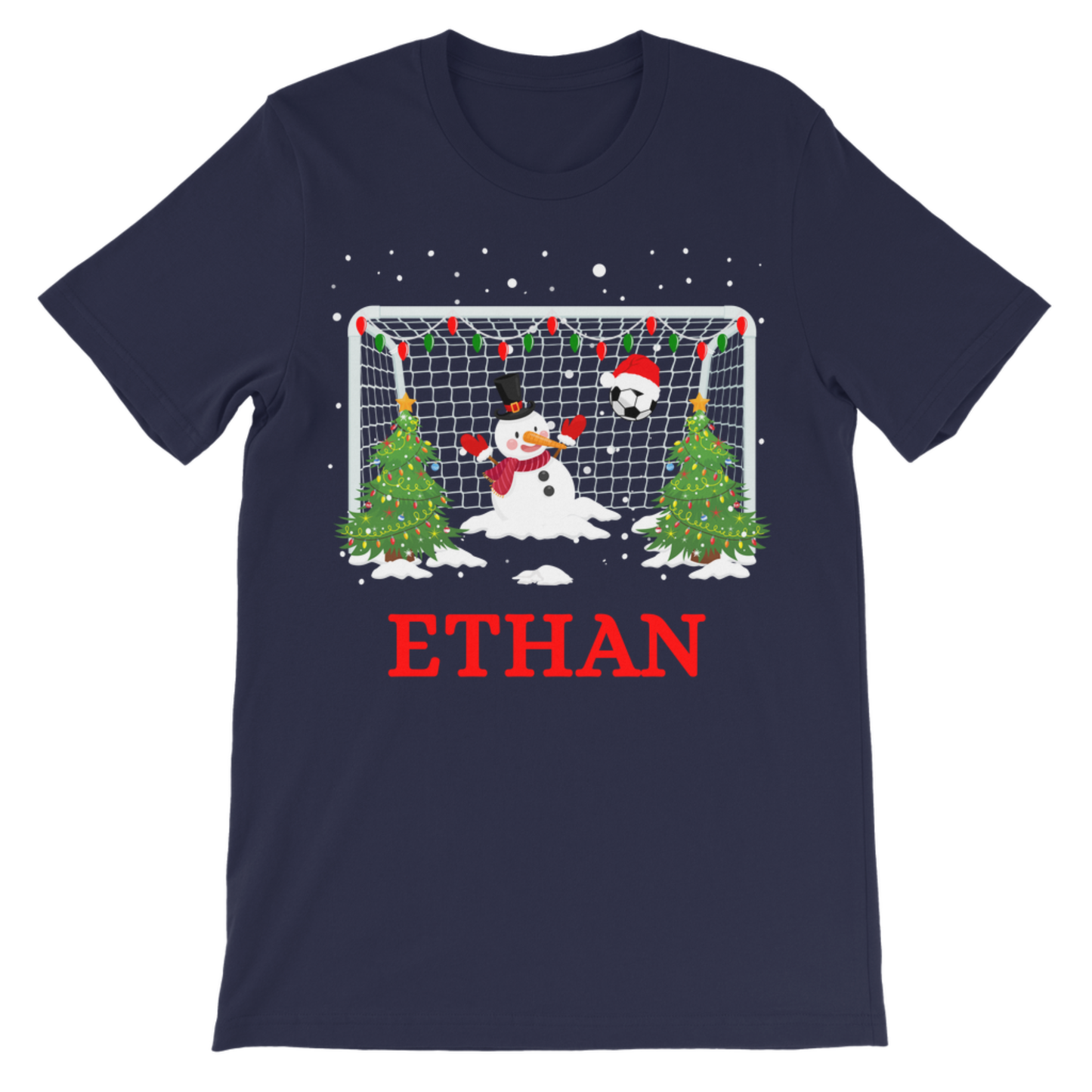 A navy blue short-sleeve t-shirt with a Christmas-themed soccer goal graphic. The graphic features a fun snowman in goal, Christmas trees, and falling snow, with the name 'ETHAN' printed in red below the graphic.