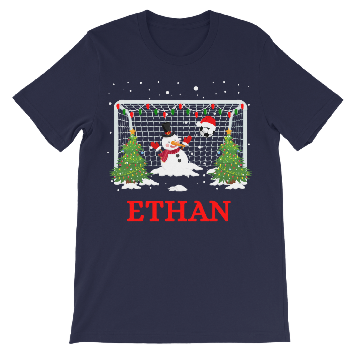 A navy blue short-sleeve t-shirt with a Christmas-themed soccer goal graphic. The graphic features a fun snowman in goal, Christmas trees, and falling snow, with the name 'ETHAN' printed in red below the graphic.