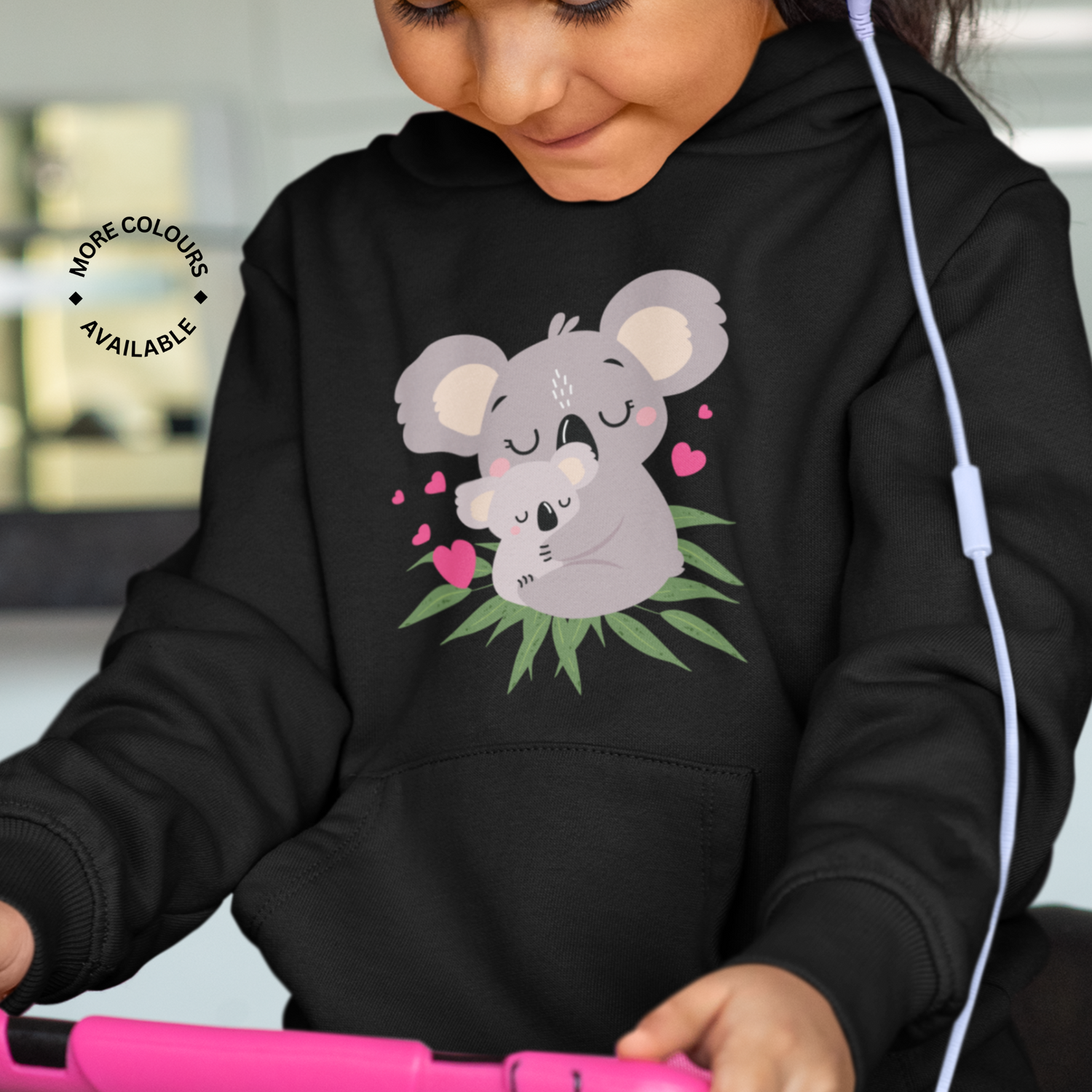 girl wearing a black hoddie with printed koala design