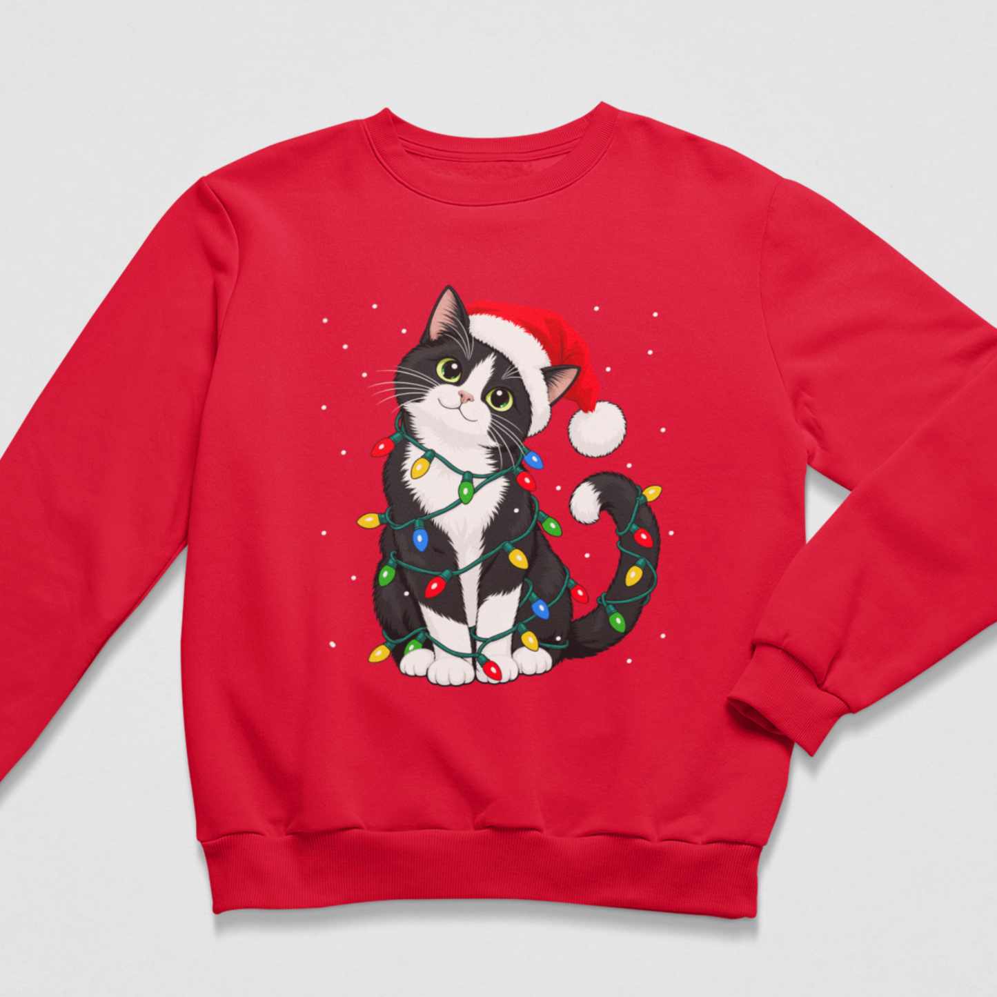 A kids red crewneck sweatshirt featuring a graphic of a black and white cat wearing a Santa hat and wrapped in colourful Christmas lights, displayed on a light grey background.