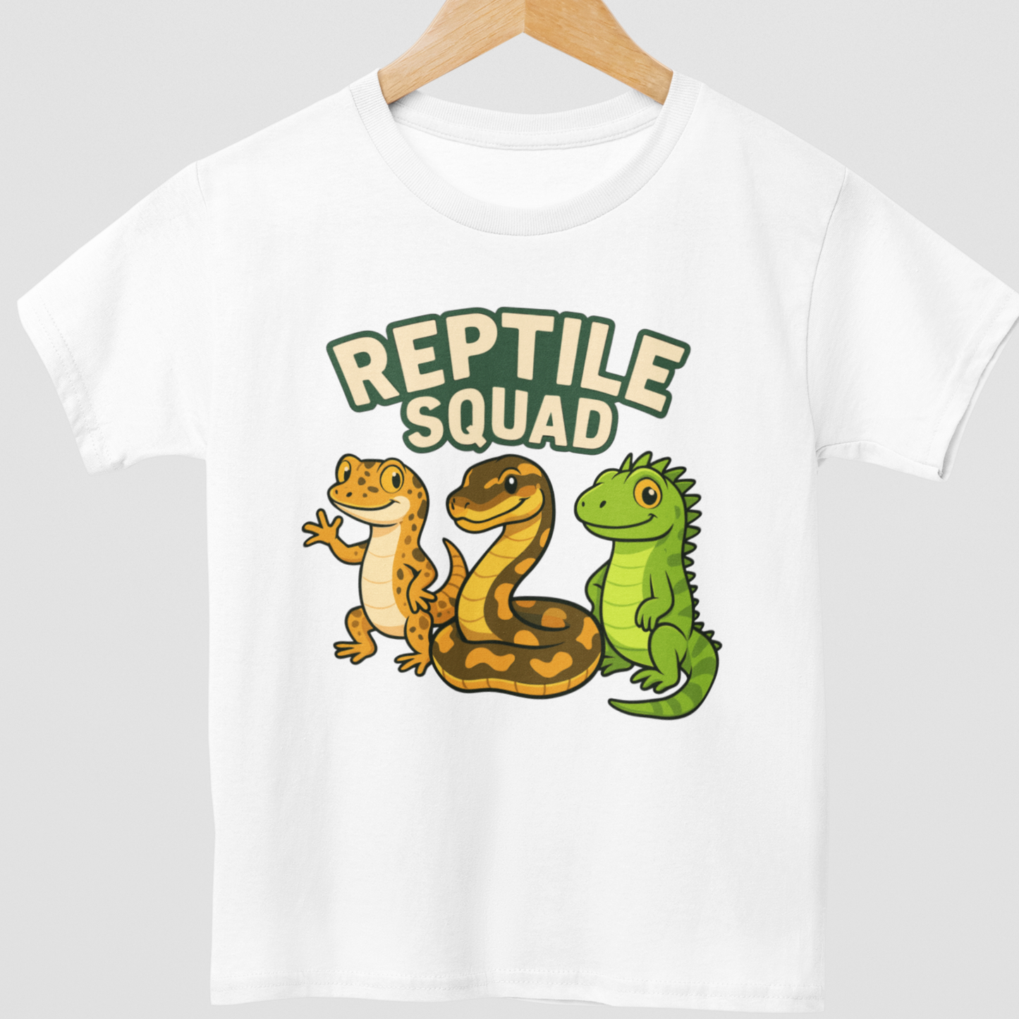 Kids white t-shirt with 'Reptile Squad' graphic featuring a snake, lizard, and tortoise styled on a wooden hanger.