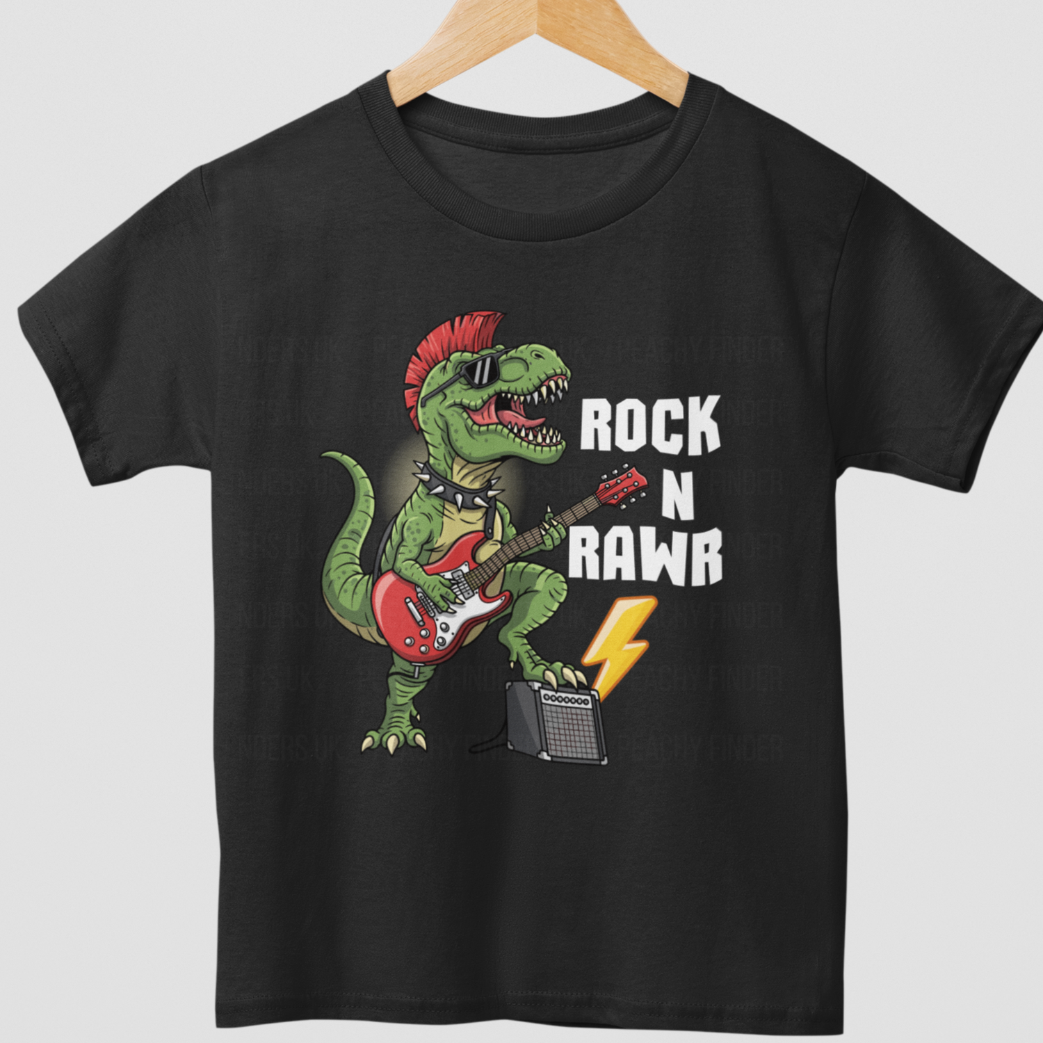 Kids ‘Rock N Rawr’ dinosaur guitar black cotton T-shirt – T-Rex playing red electric guitar with lightning bolt- styled on a wooden hanger.
