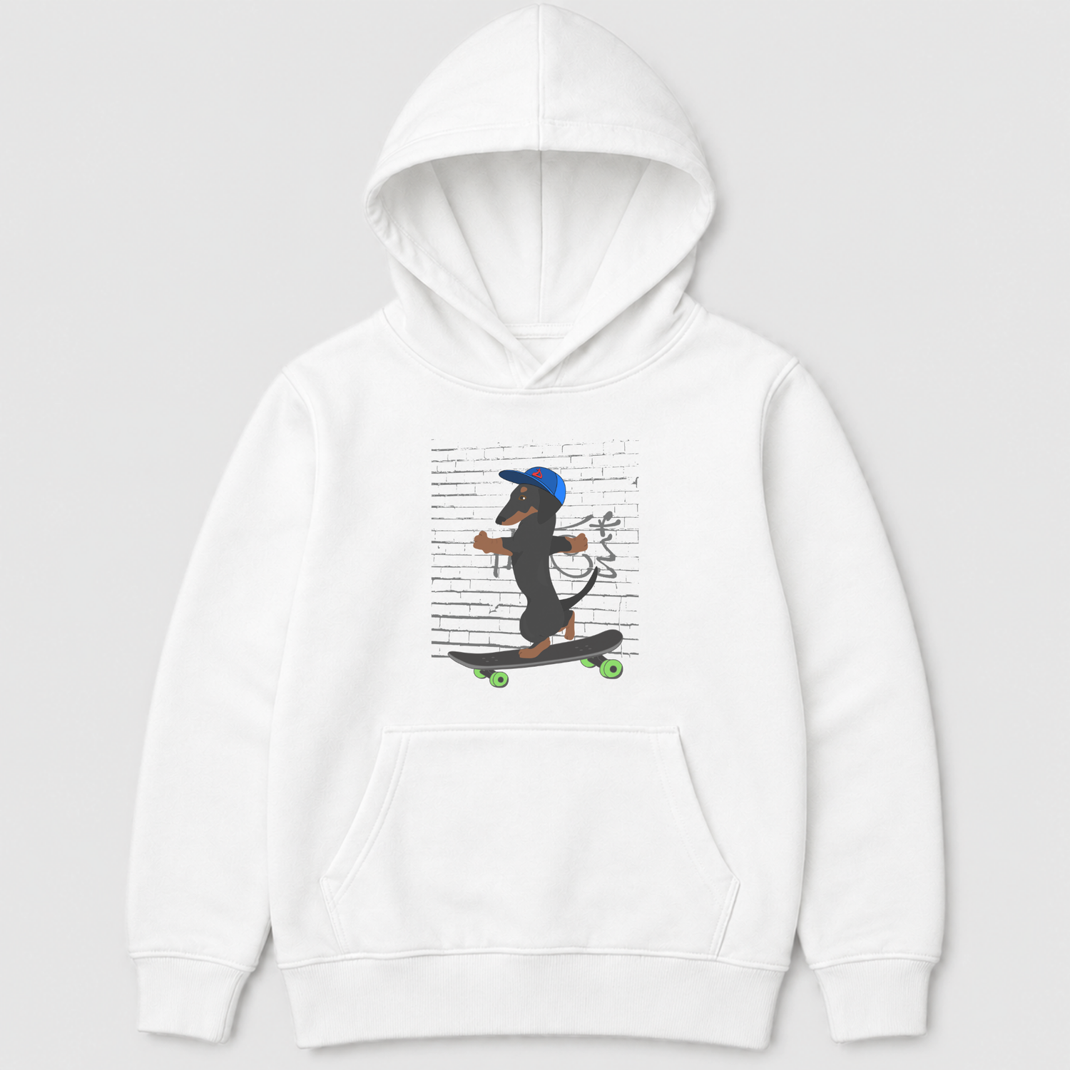 A kids white pullover hoodie featuring a cartoon graphic of a dachshund wearing a blue cap and riding a skateboard against a background of printed text, shown on a light grey studio background.