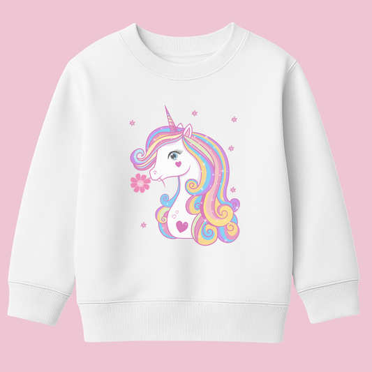 Girls white sweatshirt featuring a pastel rainbow unicorn with long colourful mane and a pink flower by its mouth, surrounded by small flower accents on a pink background.