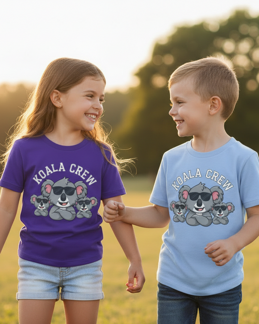 Children wearing matching Koala Crew T-shirts walking outdoors in natural sunset lighting