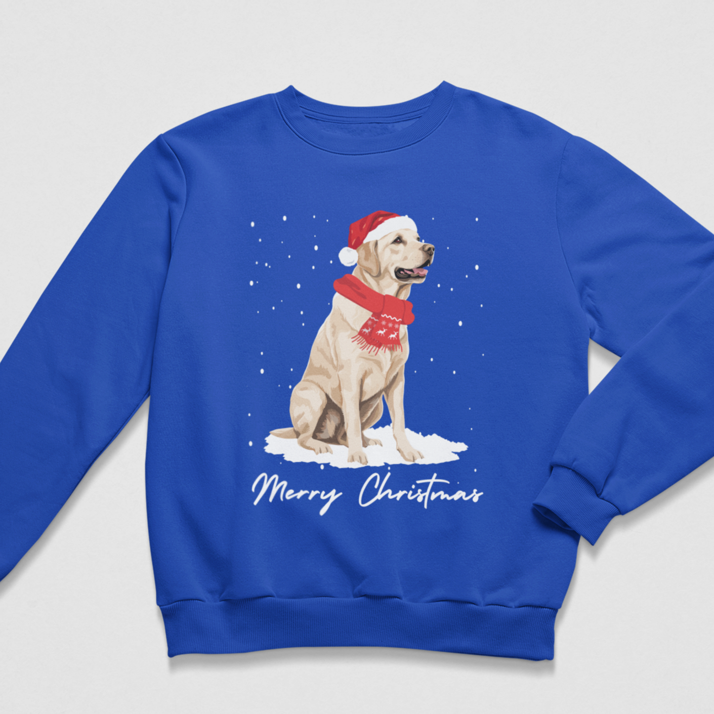 A royal blue crewneck sweatshirt featuring a graphic of a yellow Labrador Retriever wearing a red Santa hat and scarf, sitting in the snow with 'Merry Christmas' written below in white script.