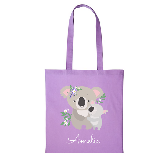 Girls lavender coloured personalised cotton tote bags featuring a mother and baby koala with floral accents, printed with the name underneath the design.