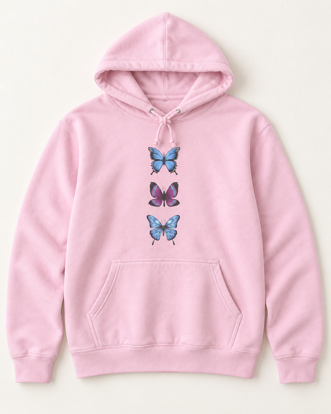 A light pink pullover hoodie featuring a graphic print of three stacked delicate butterflies on the centre chest, with two blue butterflies and one purple .