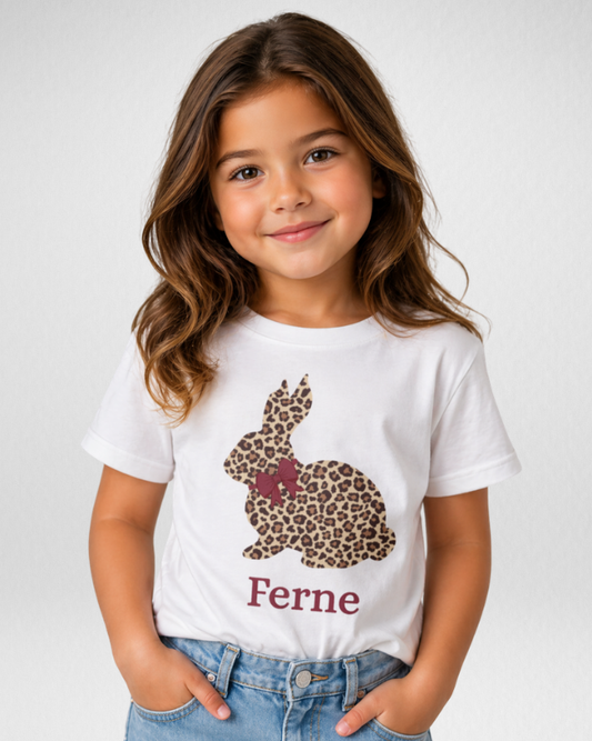 Little girl wearing personalised leopard print bunny T-shirt with name Ferne studio portrait