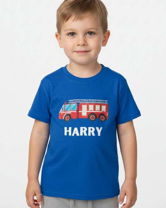 Little boy wearing royal blue personalised fire truck T-shirt with custom name print.