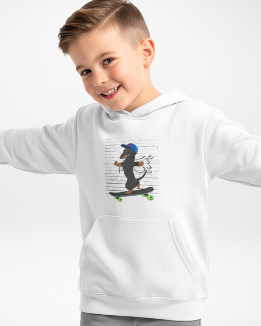 Smiling boy wearing white kids hoodie with cool sausage dog skateboard print.