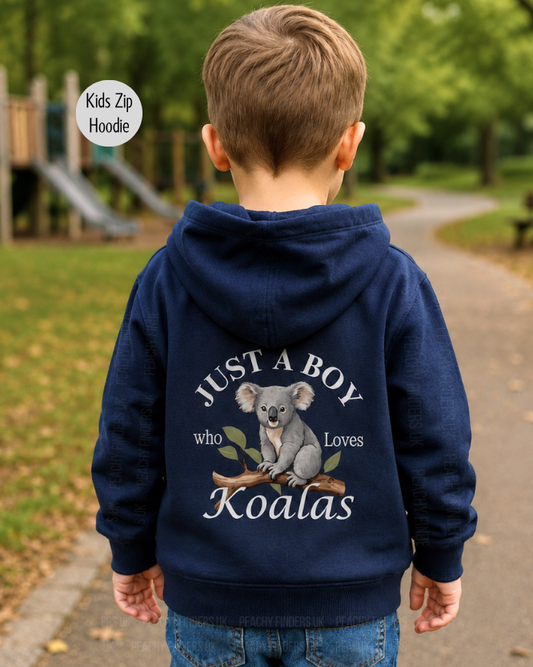 Boy wearing a navy “Just a Boy Who Loves Koalas” zip hoodie, shown from behind in an outdoor park setting with the back print clearly visible.