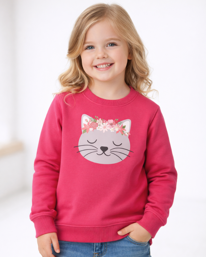 Girl modelling kids hot pink sweatshirt with floral cat graphic, blonde child wearing cat print jumper with jeans, studio kids fashion